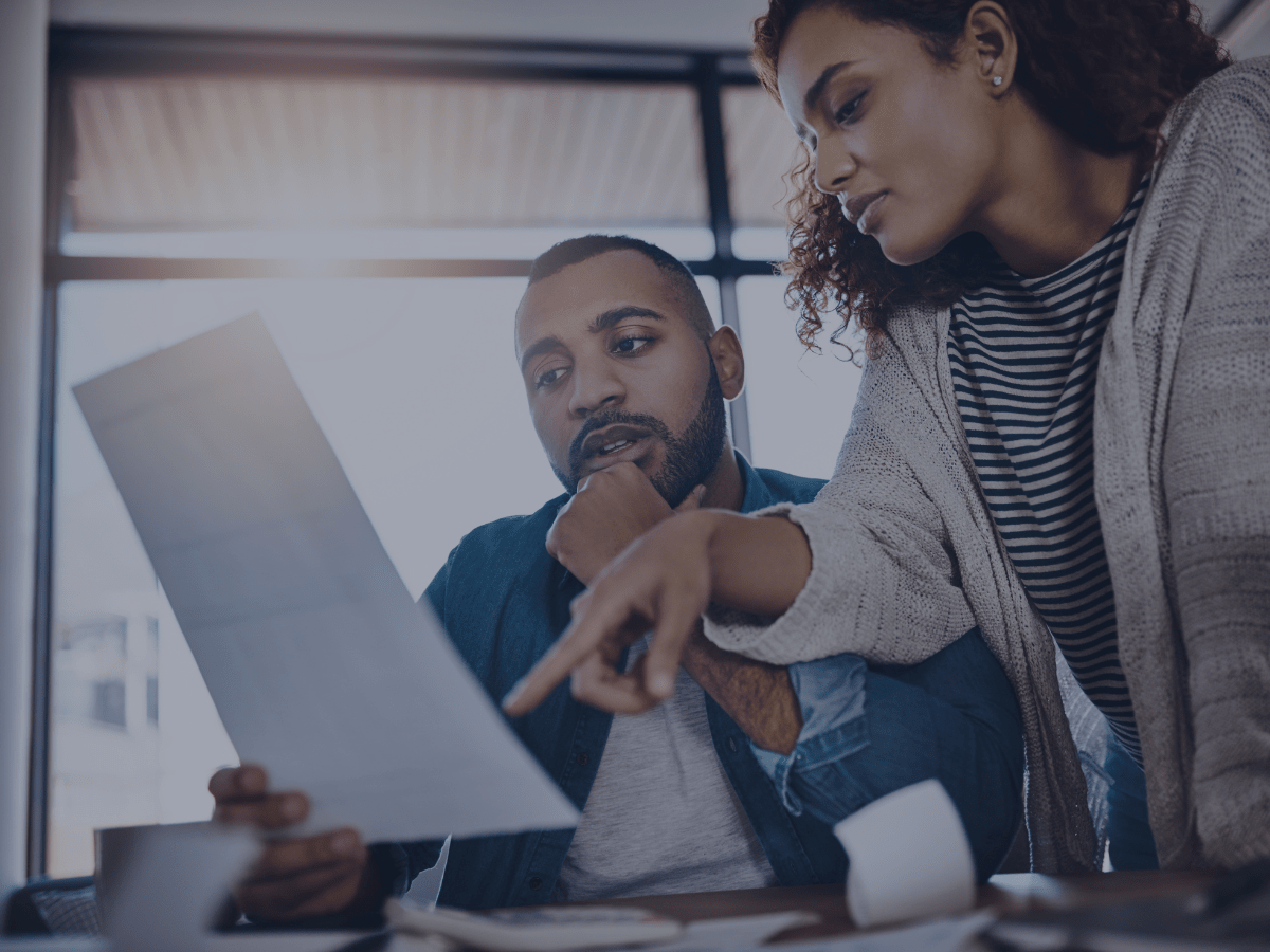 two co-workers looking at a paper