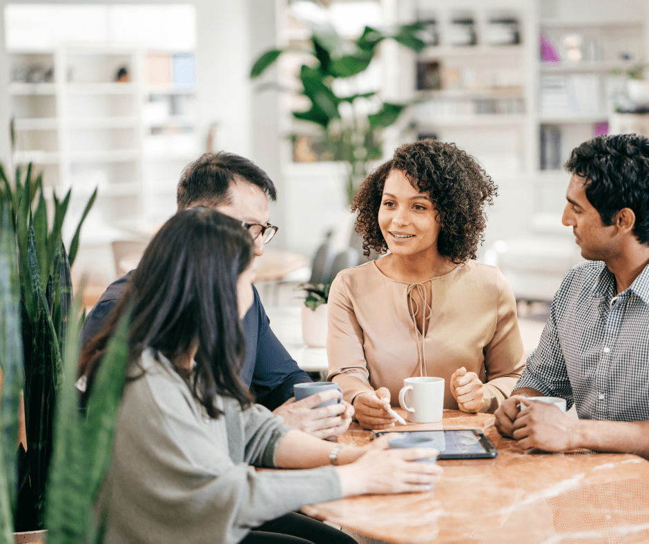 Group of people talking around a desk